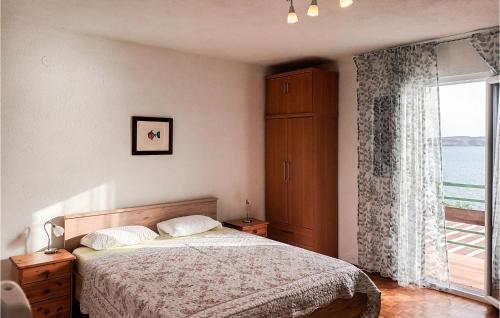 a bedroom with a bed and a large window at Holiday Home Baric Draga Baric Draga in Barić Draga