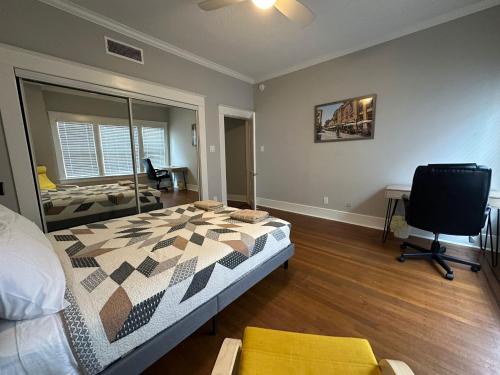 a bedroom with a bed and a desk and a television at Luxury Stay in Montrose- Parma _ the Italian Plaza in Houston