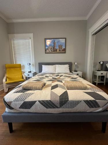 a bedroom with a bed with a quilt on it at Luxury Stay in Montrose- Parma _ the Italian Plaza in Houston