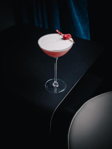 a drink in a martini glass on a table at Liu Men Melaka in Melaka