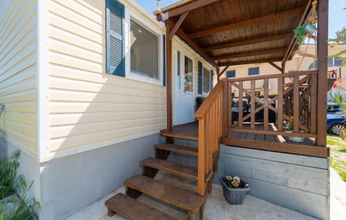 a wooden staircase leading up to a tiny house at Lovely Stacaravan In Ljubac With Wifi in Ljubač