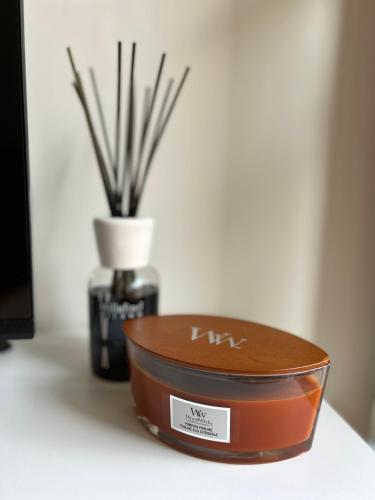 a container of soy sauce next to a vase with sticks at Dolce Casa in Lecco