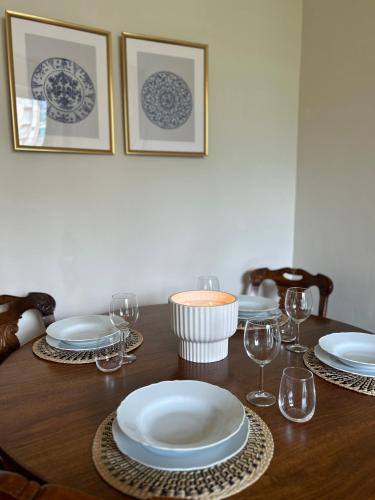a wooden table with plates and wine glasses on it at Dolce Casa in Lecco