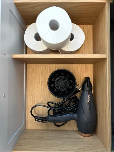 a drawer with a computer mouse and toilet paper at Dolce Casa in Lecco