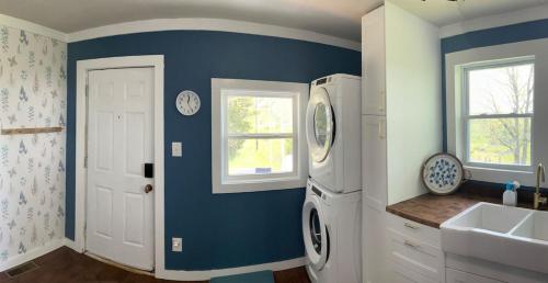 a bathroom with a white refrigerator and a sink at Mountain View Cottage in Ashland