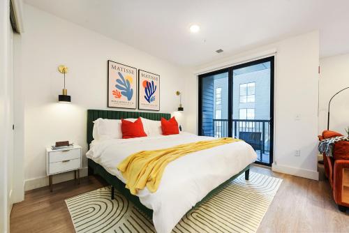 a bedroom with a large bed with red pillows at LUX Studio King Bed Free Parking Gym New in Pittsburgh
