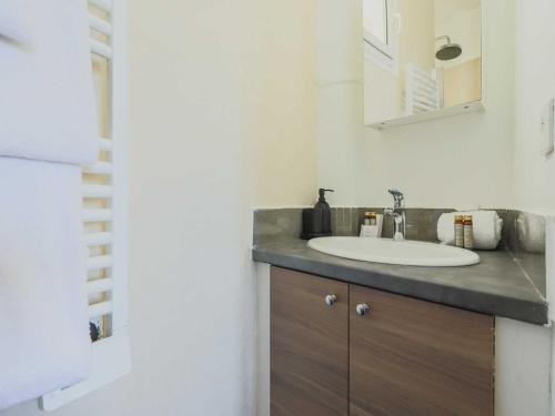 une salle de bain avec un lavabo et un miroir dans l'établissement Charming flat -1BR-4P- Paris 17e, à Paris