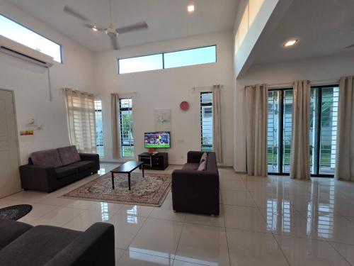 a large living room with couches and a tv at Siantan In Paya Rumput Near Std Hang Jebat, Sg Udang & UITM Lendu in Melaka