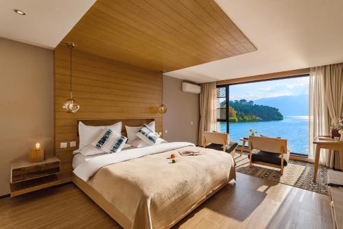 a bedroom with a large bed and a large window at Dali Shuanglang seven-room sea view hotel in Dali Shuanglang