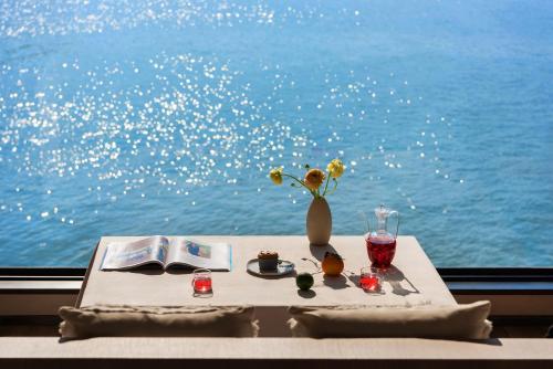 a table with a vase of flowers and a book at Dali Shuanglang seven-room sea view hotel in Dali Shuanglang