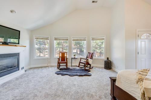 a bedroom with a bed and a desk and a fireplace at 2 Mi to Lake Estes Home with Deck and Grill in Estes Park
