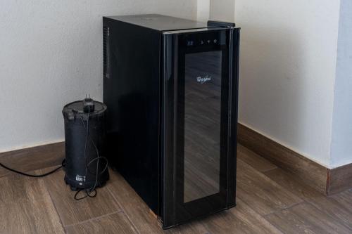 a black computer tower sitting next to a trash can at Ecohouse Cieneguilla in Pachacamac