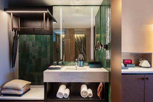a bathroom with a sink and a shower at 黄石未苏湾花间亭飞花 in Xialu