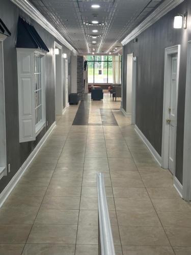 a hallway of an office building with a tile floor at Days Hotel by Wyndham Williamsburg I-64 in Williamsburg