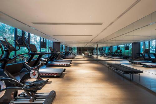 a gym with rows of treadmills and elliptical machines at 黄石未苏湾花间亭飞花 in Xialu
