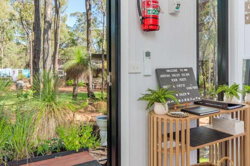 a door to a garden with a sign on it at Jarrah Valley Escape by Tiny Away in Bedfordale
