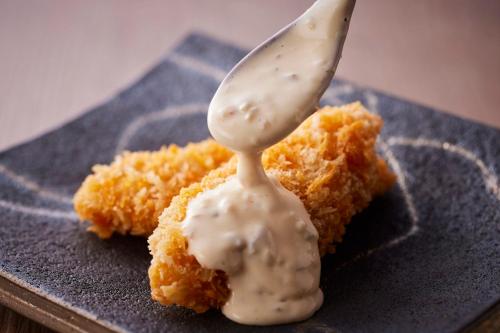 a spoon with sauce on top of a piece of food at KAMENOI HOTEL Nara in Nara