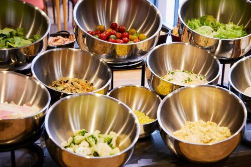 a bunch of metal bowls filled with different types of food at KAMENOI HOTEL Nara in Nara