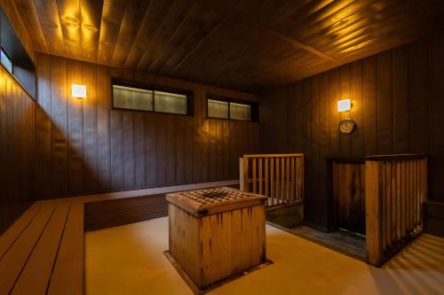 an empty wooden room with a table in the middle at Spa Resort Hawaiians Monolith Tower in Iwaki