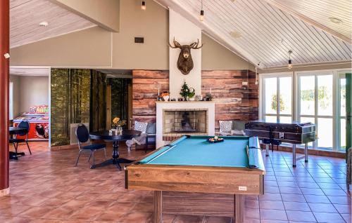 a room with a pool table and a fireplace at 2 Bedroom Beautiful Home In Hok in Hok