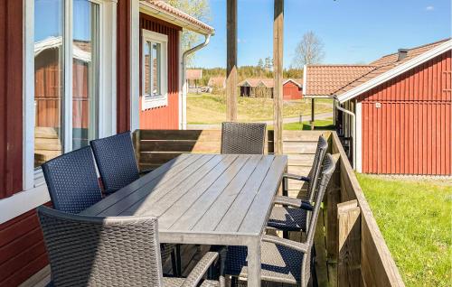 a wooden table and chairs on a deck at 2 Bedroom Awesome Home In Hok in Hok