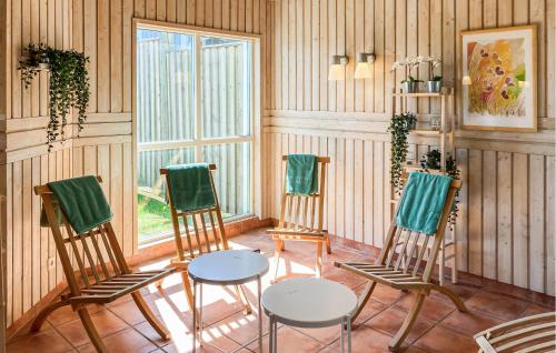 a room with four chairs and a table and a window at 2 Bedroom Awesome Home In Hok in Hok