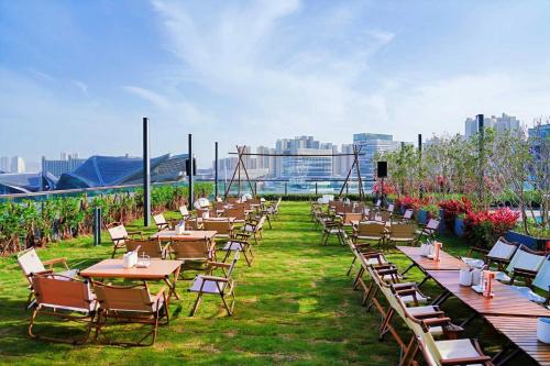 a row of tables and chairs on a roof at Zhuhai Marriott Hotel Jinwan in Zhuhai