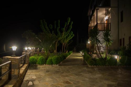 a courtyard at night with lights and a building at Guesthouse Enastron in Chorefto