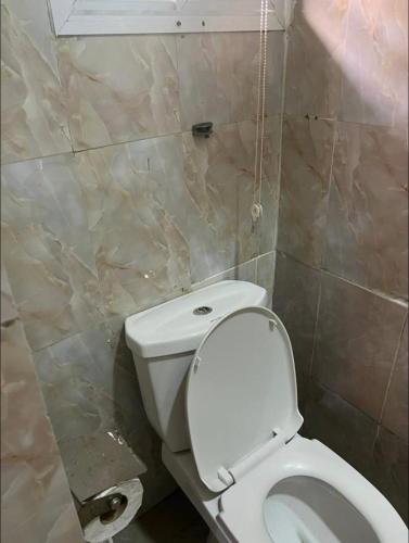 a bathroom with a white toilet in a room at Emerald Ikate Lekki in Lekki