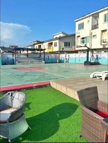 a basketball court with chairs and a basketball hoop at Emerald Ikate Lekki in Lekki