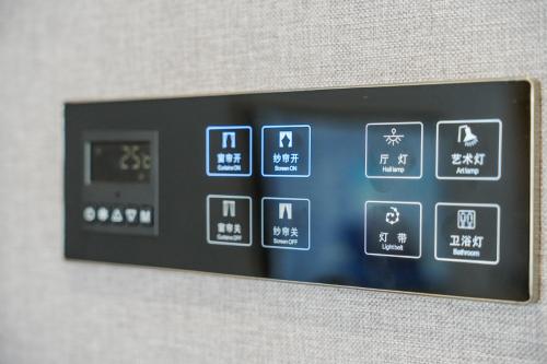 a close up of a remote control on a wall at Kelly Jinyue Hotel in Chengdu