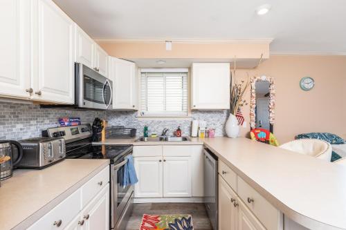 a kitchen with white cabinets and a sink at North Ocean city newly Remodeled in Ocean City