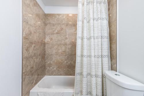 a bathroom with a tub and a shower curtain at North Ocean city newly Remodeled in Ocean City