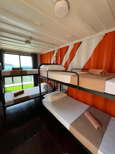 a room with three bunk beds in a train at Perhentian Nemo Chalet in Perhentian Island