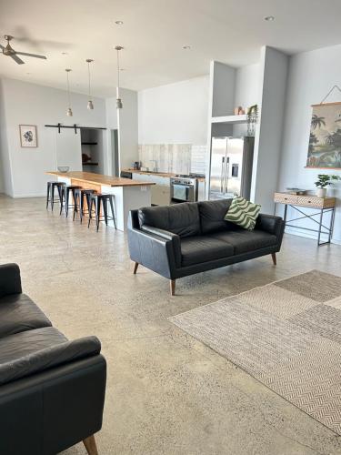 a living room with a couch and a table at Birdys Retreat in Rarotonga