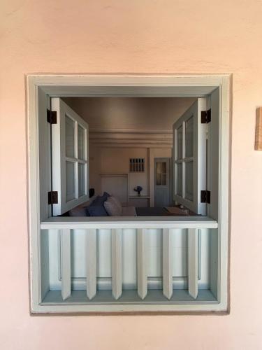 a view of a bedroom through a window at Encanto Azul in Villa de Leyva