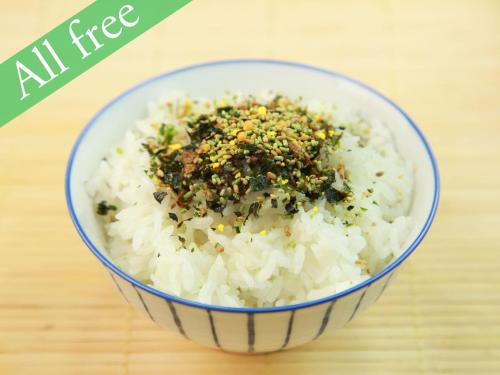 a bowl of rice with spices on top of it at Anshin Oyado Shinjuku Ekimaeten in Tokyo