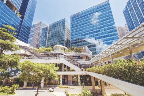 a building with a staircase in a city with tall buildings at BGC Suites Uptown in Makati