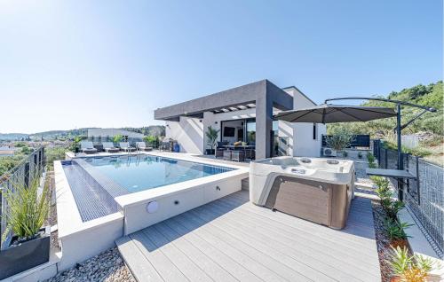 a house with a swimming pool on a deck at Beautiful Home In Lumbarda in Lumbarda