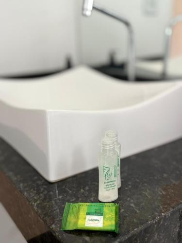 a bottle of milk sitting on a table in a room at Pousada Ipê do Lago in Capitólio