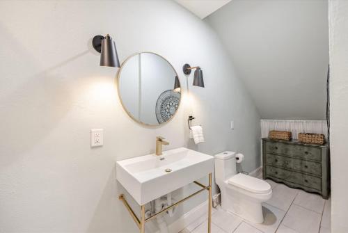 a white bathroom with a sink and a mirror at Waterfront Studio Just minutes to Naples Beaches in Naples