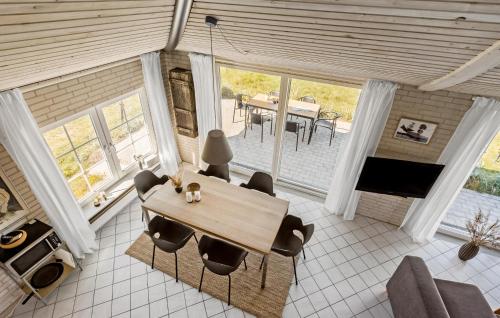 a living room with a wooden table and chairs at Cozy Home In Knebel With Wifi in Knebel