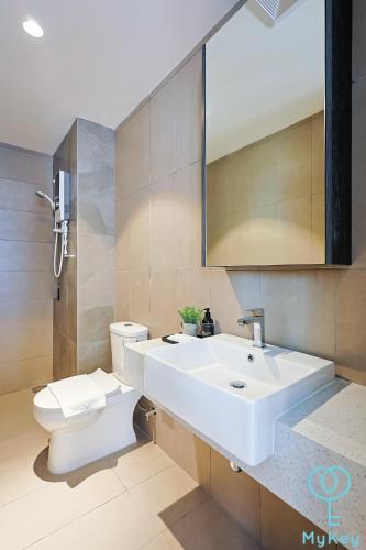 a bathroom with a white sink and a toilet at Paxtonz Seasonal Suites in Petaling Jaya