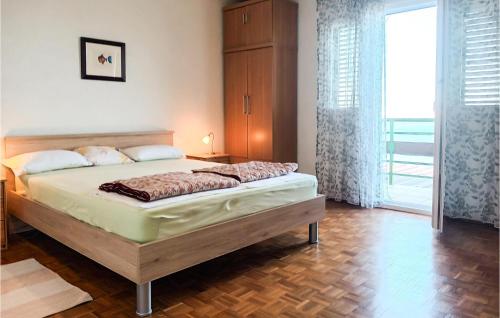 a bedroom with a bed and a large window at Holiday Home Baric Draga Baric Draga in Barić Draga
