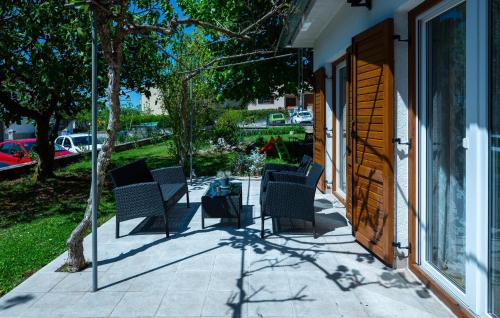 a group of chairs sitting on a porch at 3 Bedroom Cozy Home In Zminj in Žminj