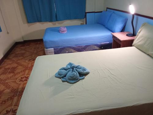 a stuffed animal on a bed in a room at Shore Manor in Supa
