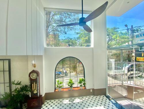 a ceiling fan in a lobby with a window at Oasis Home in Nha Trang