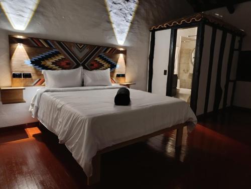 Postel nebo postele na pokoji v ubytování Hotel Hacienda Anacaona - San Agustín
