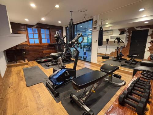 a gym with several exercise equipment in a room at Nature Boutique Hotel Ratchayothin in Bangkok