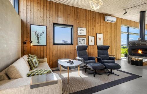 a living room with a couch and chairs and a fireplace at Two-Bedroom Holiday Home In Vinderup in Vinderup